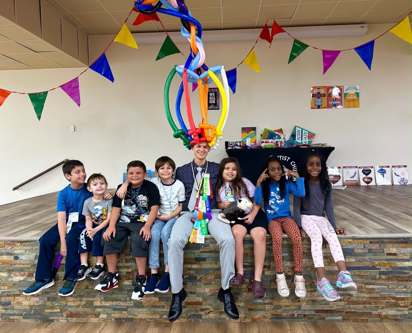 Children gathered with a church leader