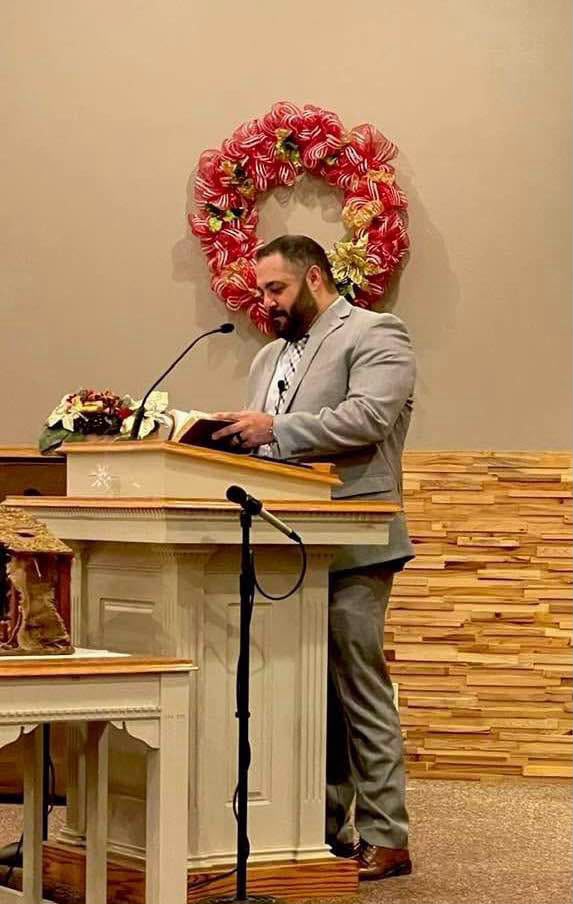 Pastor Rey Martinez preaching from the pulpit
